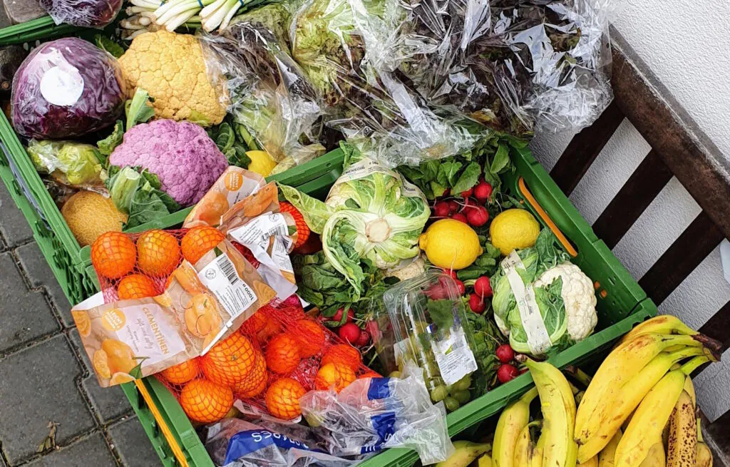 Gerettete Lebensmittel In grünen Kisten liegt viel gerettetes Gemüse und Obst.